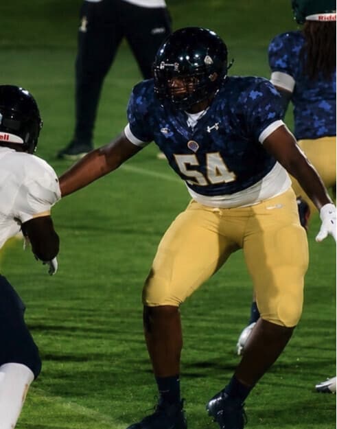 Landrey Thompson, number 54, in his offensive tackle stance during an Under Armour All-American game