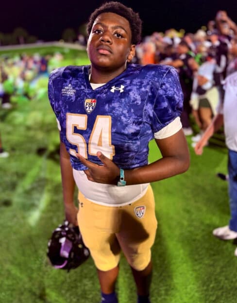 Landrey Thompson on the sideline at night in his number 54 FBU jersey