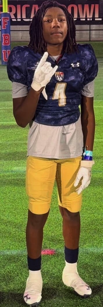 Urijah Springs, number 4, throwing up a hand sign on the field at the FBU All-American Bowl