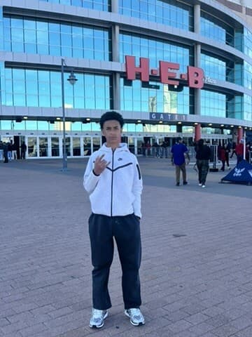 Vonzelle Brown II in a white hoodie in front of the H-E-B building in San Antonio